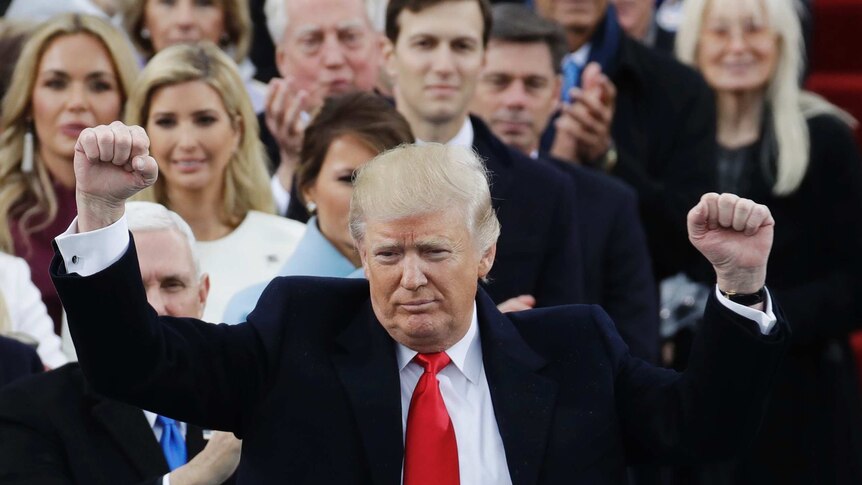 President Donald Trump pumps his fist after delivering his inaugural address