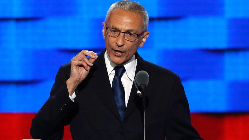 John Podesta makes a pinching motion with his hand as he speaks at the Democratic National Convention.