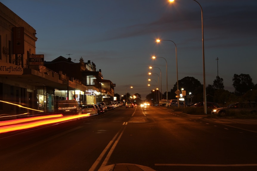 Collie's main street at night with street lights lighting up the street.