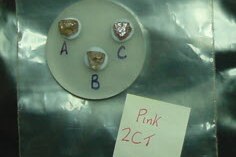 Three pink diamonds on a round piece of paper marked A, B and C, next to a note: Pink 2CT.