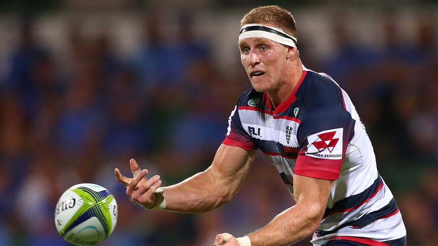 Reece Hodge passes the ball in the Melbourne Rebels' Super Rugby opener