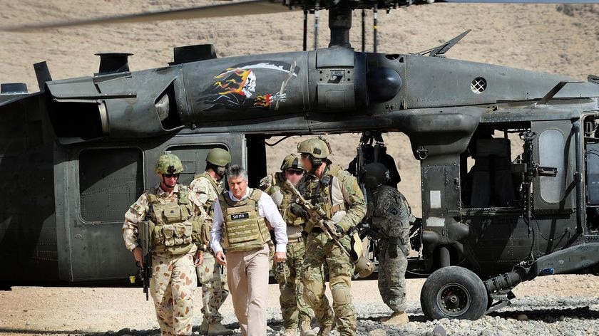 Defence Minister Stephen Smith disembarks from a Blackhawk helicopter