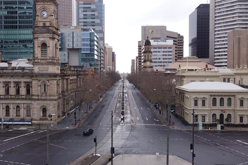 A city street with few cars and people on it