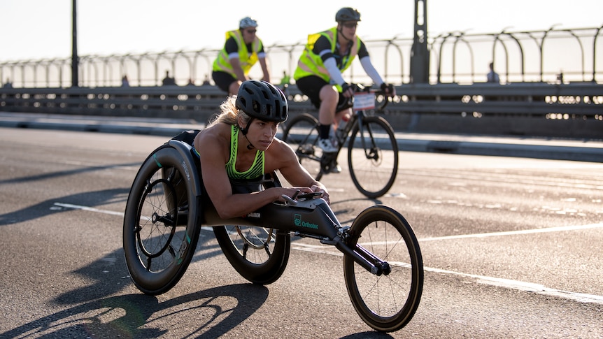An Australian wheelchair athlete rolls across the Sydney Harbour Bridge during a marathon race.