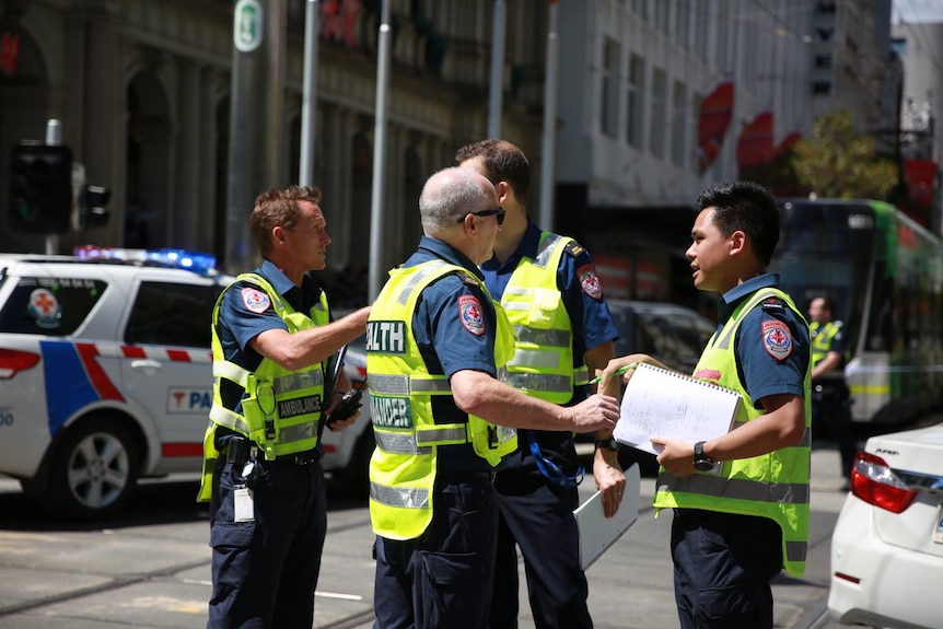 Paramedics cluster at the Bourke Street scene.