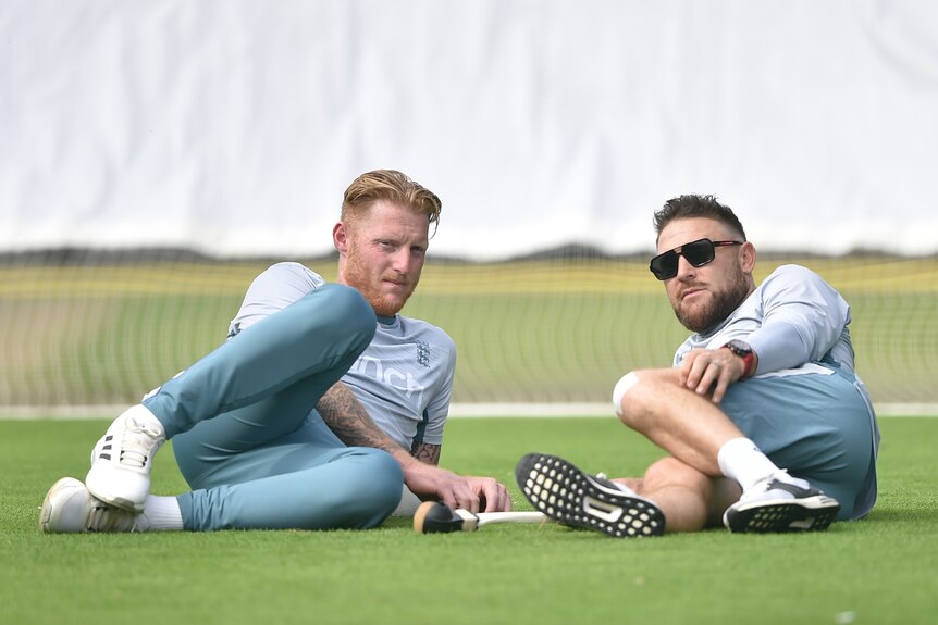 Ben Stokes and Brendon McCullum lie on the ground