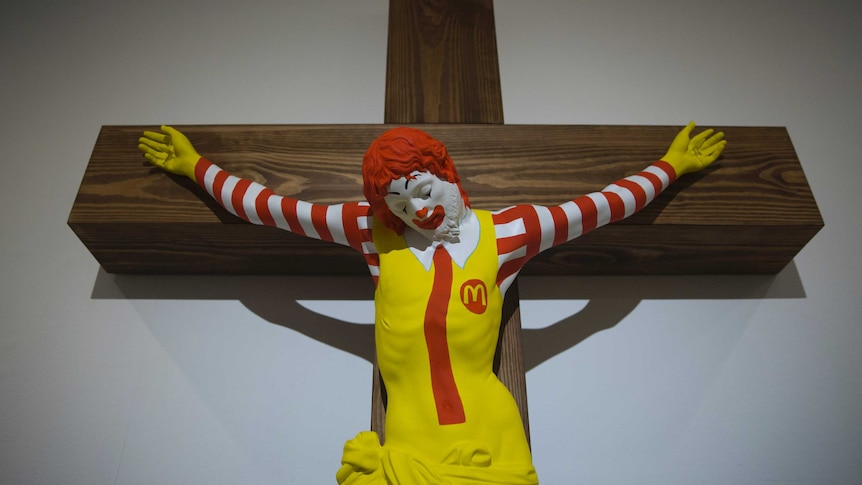 An exhibit showing a cruficied Ronald McDonald.