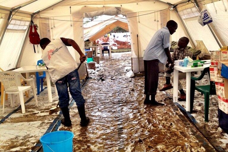 MSF workers clean up the clinic in Jamam after a night of rain.