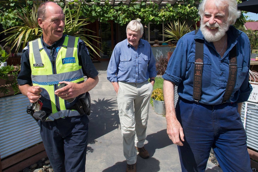 Senior Constable Paul Delaney emerges from a cafe.