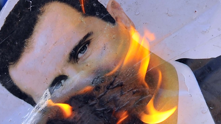 Rebels burn picture of Bashar al-Assad