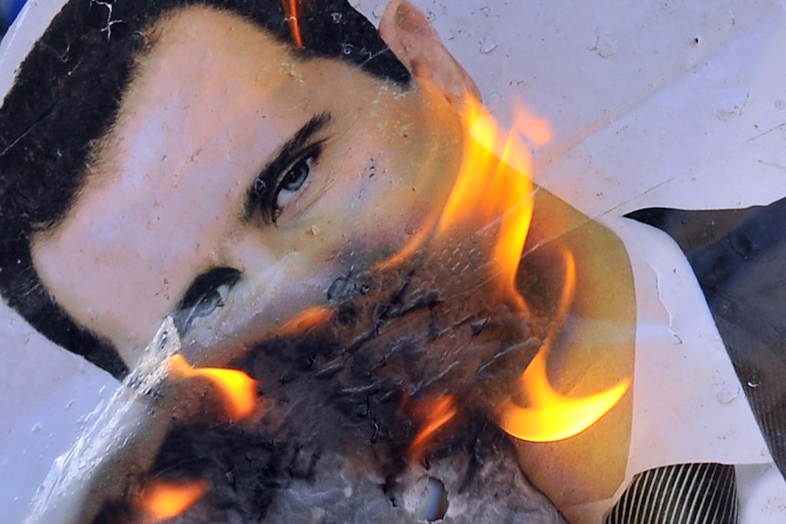 Rebels burn picture of Bashar al-Assad