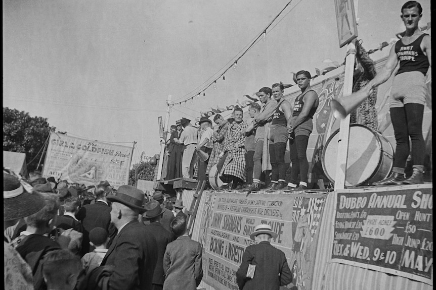 Fighters stand on display outside the Jimmy Sharman Boxing Troupe tent at the Sydney Royal Easter Show in 1939.