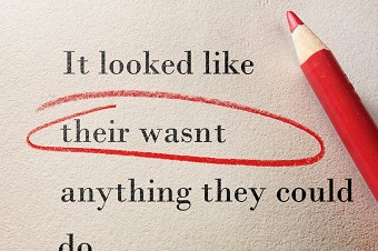 A red pencil circles spelling mistakes on a piece of paper