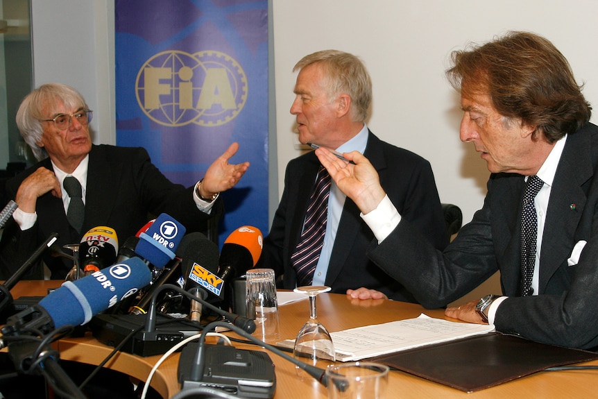 Max Mosley, Luca Cordero de Montezemolo and Bernie Ecclestone speak at a press conference.