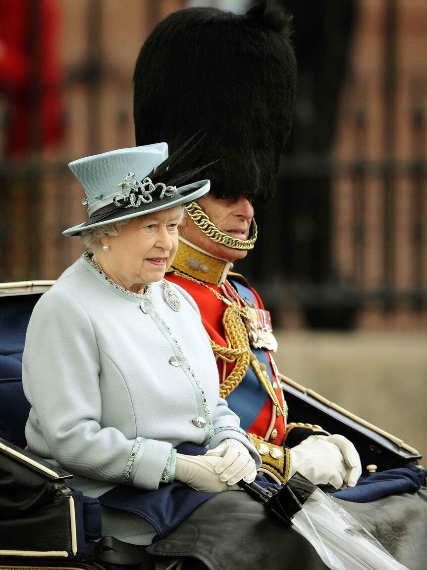 Britain's Queen Elizabeth and Prince Philip sit in a horse drawn carriage