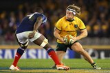 Tight contest ... Wallabies captain Michael Hooper meets the French defence