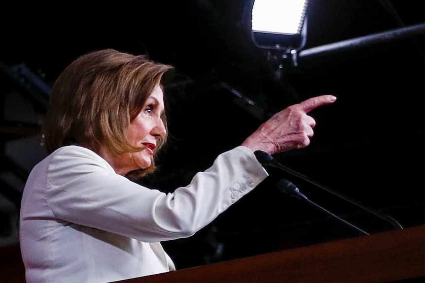 US House Speaker Nancy Pelosi points at a reporter