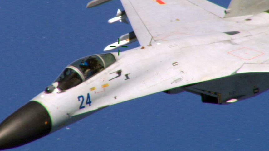 Chinese fighter jet flying close to a US navy plane