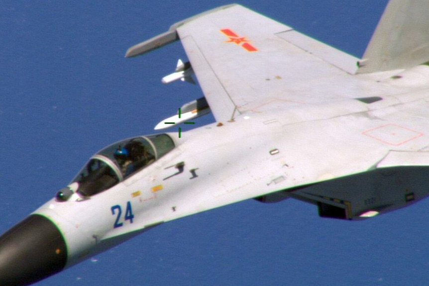 Chinese fighter jet flying close to a US navy plane