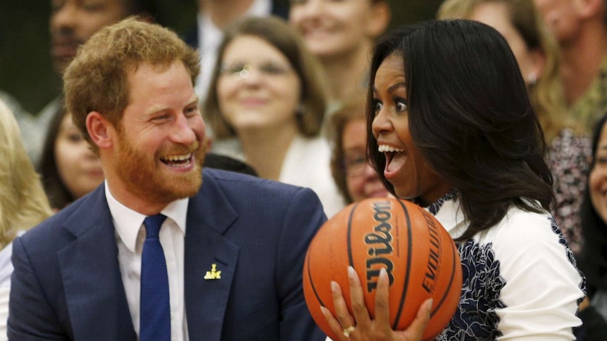 Prince Harry hands Michelle Obama the basketball