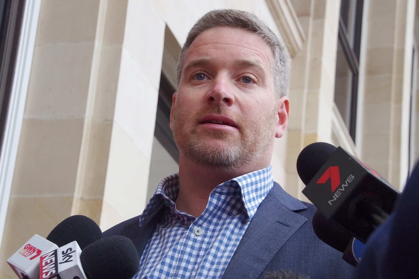 Head and shoulder shot of Brendon Grylls standing outside of the WA Parliament.