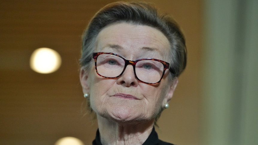 Elizabeth Young wearing black and glasses