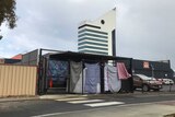 A shelter for Bunbury's homeless community set up in a car park, enclosed with sheets. The Bunbury tower is in the background.