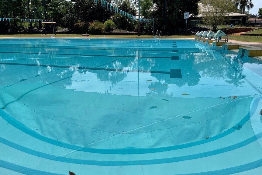 the bottom liner of the pool can be seen floating up in the water