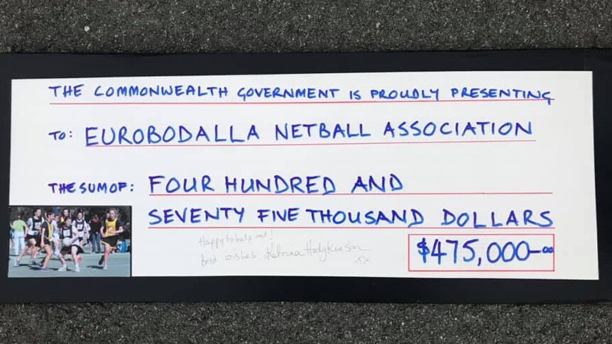 Details of the novelty cheque Katrina Hodgkinson handed to members of the Eurobodalla Netball Association.