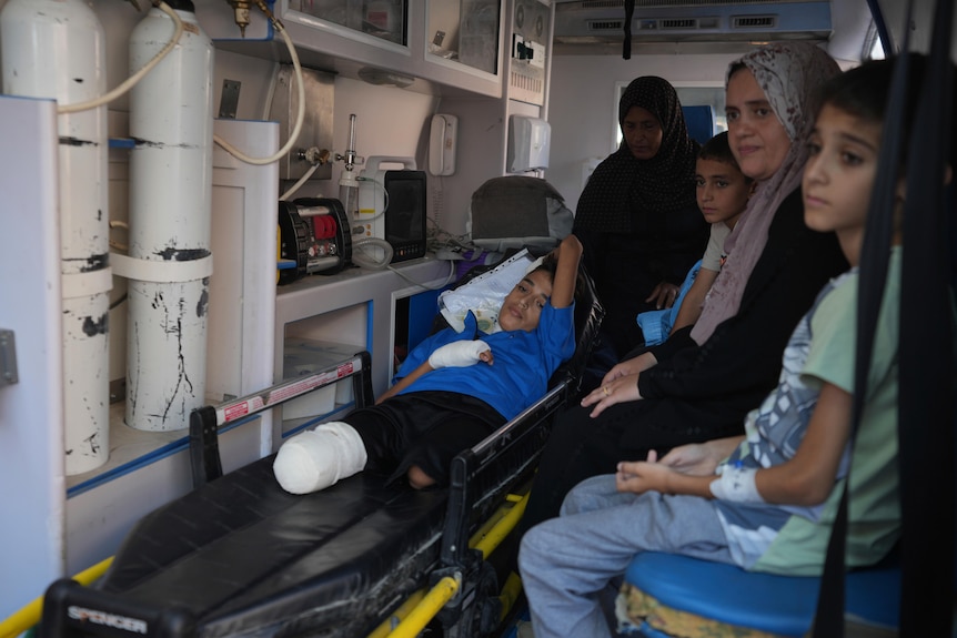 An amputee child sitting in an ambulance. 
