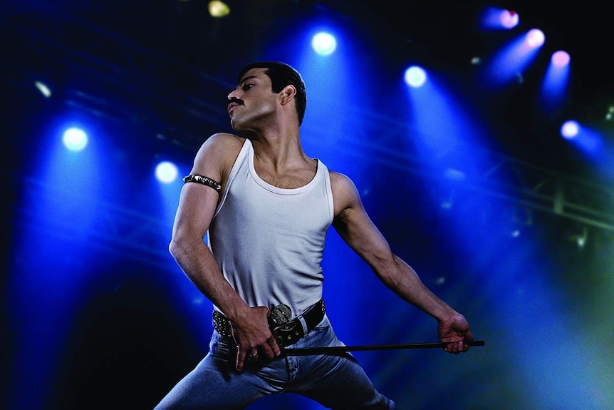 A still from the 2018 Freddie Mercury Biopic Bohemian Rhapsody showing Freddie posed on stage