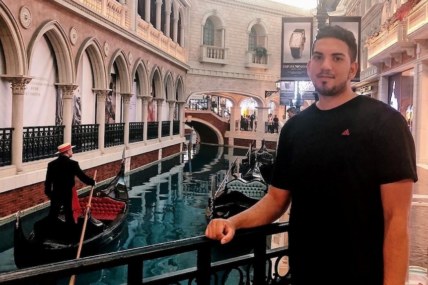 Luigi pictured in front of canals while overseas