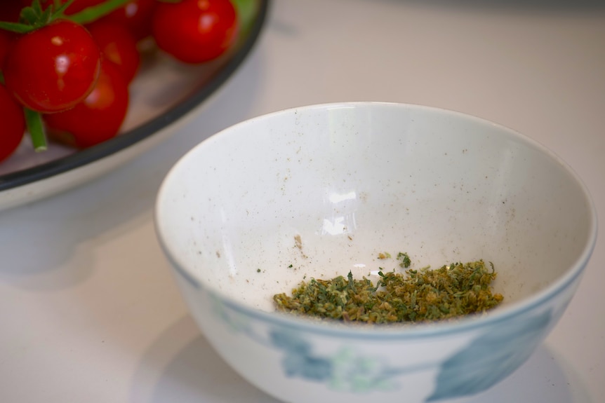 A bowl containing cannabis leaves.