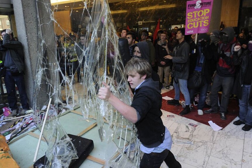 Demonstrators break windows of the Conservative Party headquarters during a protest in London (Reuters: Paul Hackett )