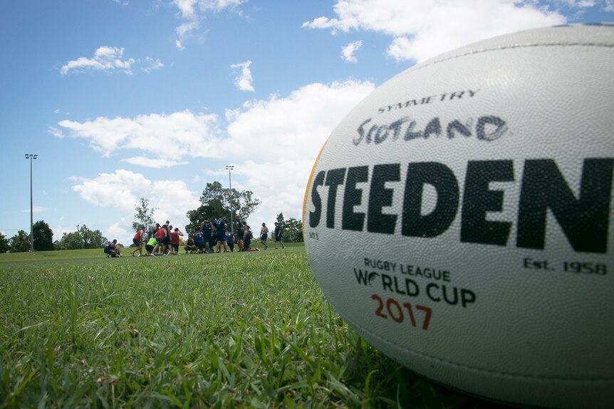 Rugby league football with Scotland written on it sits on a field in Cairns.