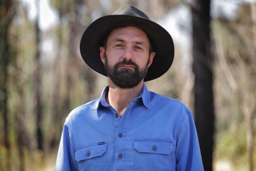 Dennis Gascoigne, a man wearing a blue shirt and a hat.