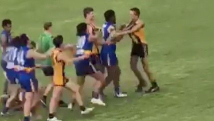 A group of young footballers get into a punch on during a game