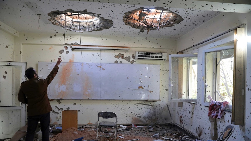 A Kabul University room pock marked by bullet holes.