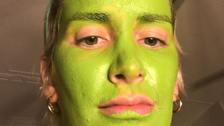 Lucinda Price dresses as Shrek wearing green make up and ogre ears