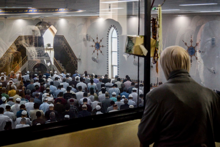 A women looks down over the men's prayer area in Lakemba Moaque.