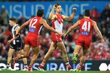 Callum Sinclair of the Swans (C) gestures after kicking a goal against St Kilda at the SCG.
