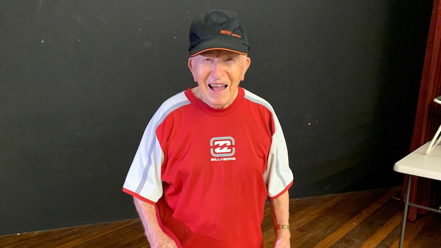 100 year old table tennis player Teddy Marchwicki smiling and limbering up before playing.
