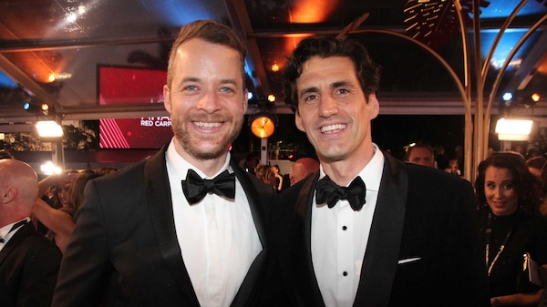 Two young men smile for the camera on the red carpet for the 2019 Logies.