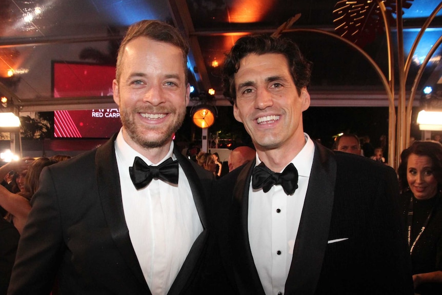 2019 Logies hosts Hamish Blake and Andy Lee smile for the camera on the red carpet.