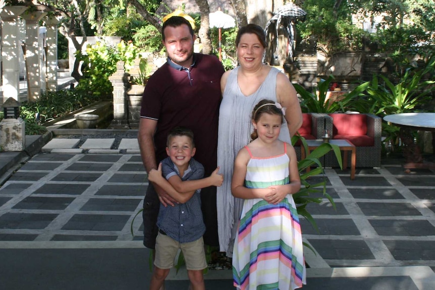 Nick Lardieri and Deb Dennison outside with their children.