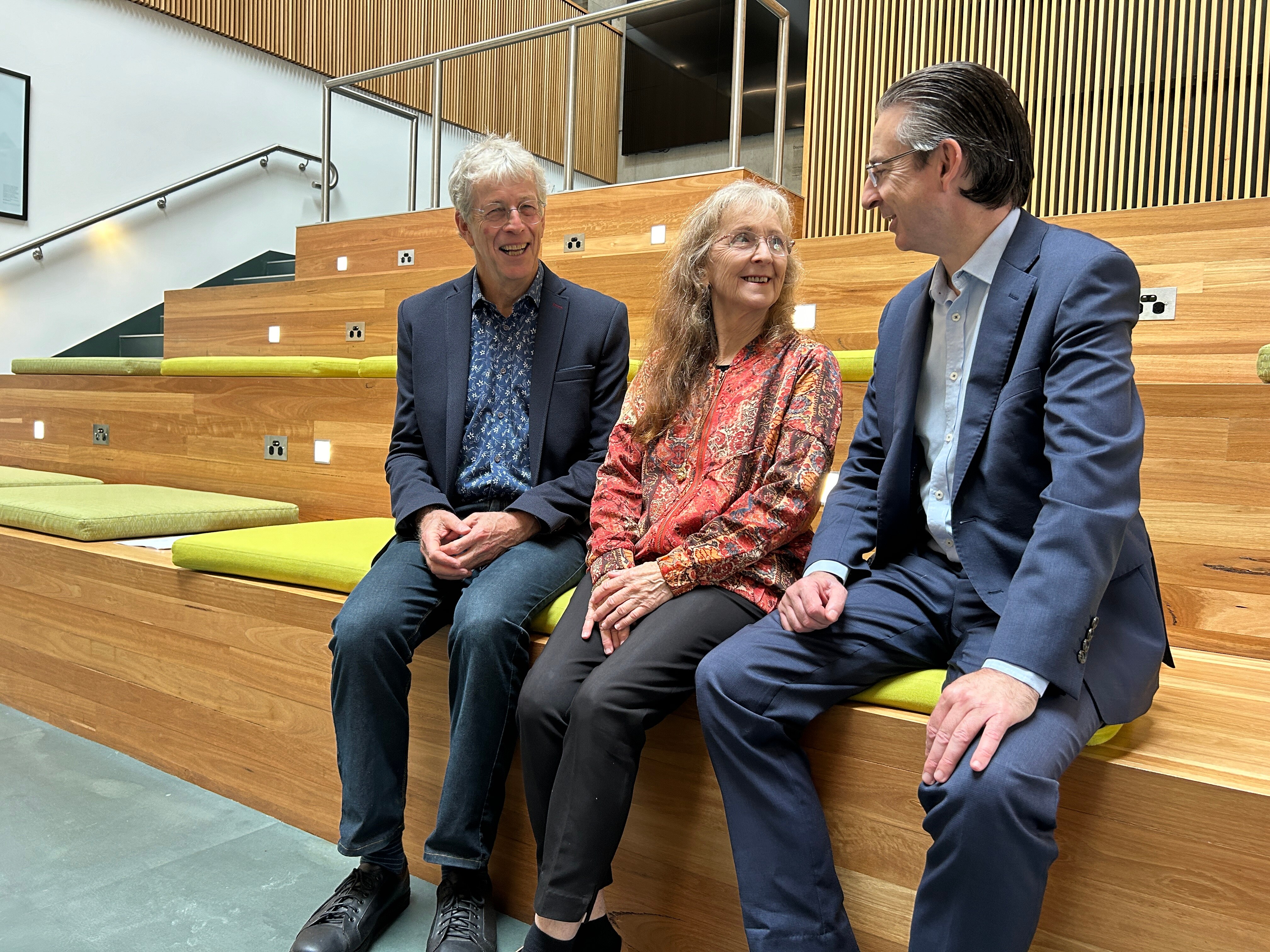 two men and a woman sit together