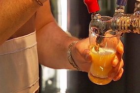 a man pulling a beer at a pub