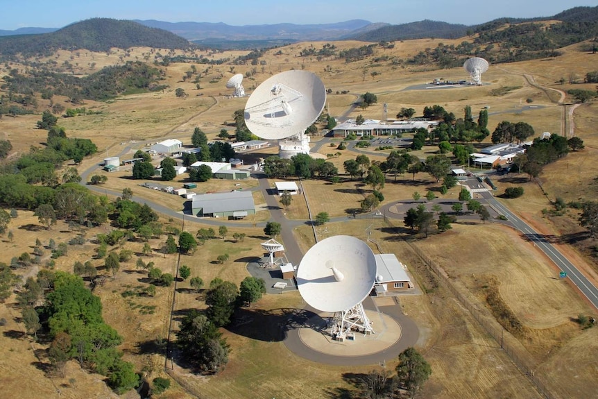 An aerial shot of the Canberra Deep Space Communication Complex with massive, white satellites.