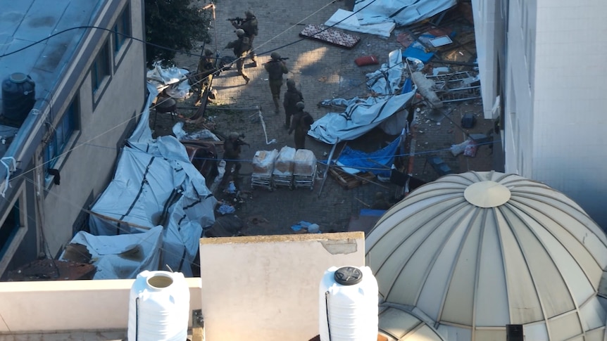 israeli soldiers can be seen roaming a courtyard littered with tents