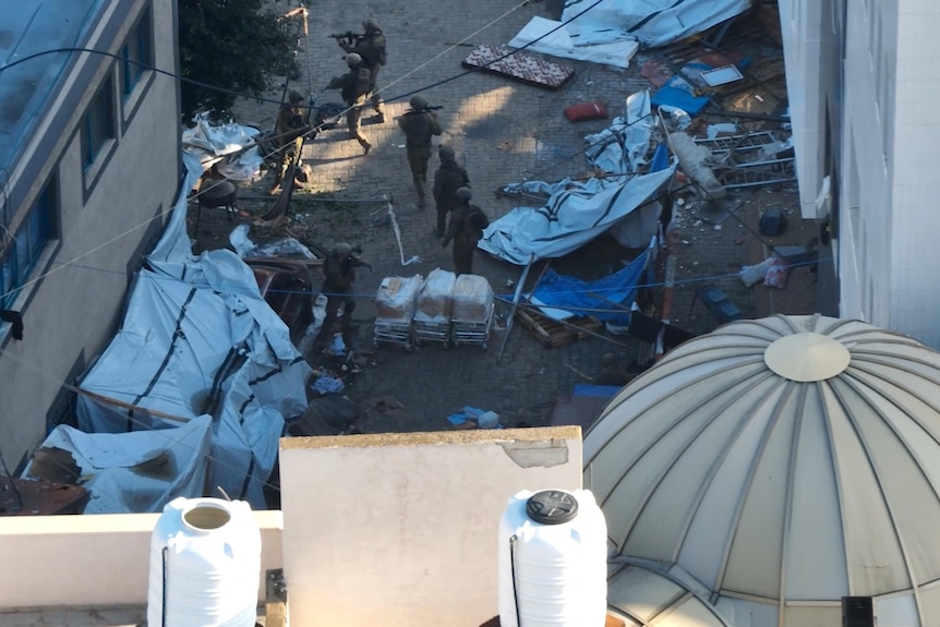 israeli soldiers can be seen roaming a courtyard littered with tents